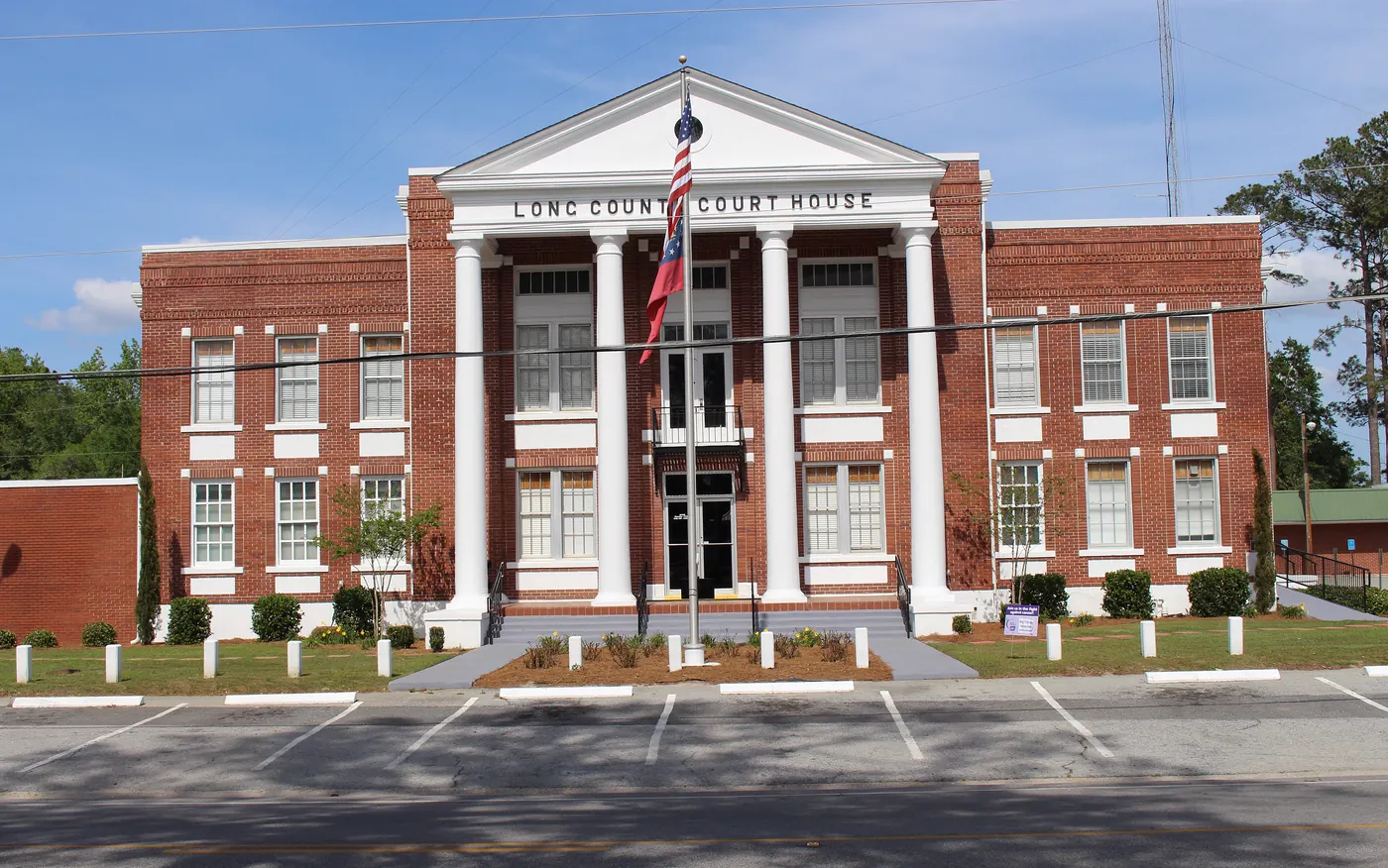 The red-brick Long County Courthouse with white columns in downtown Ludowici, Georgia