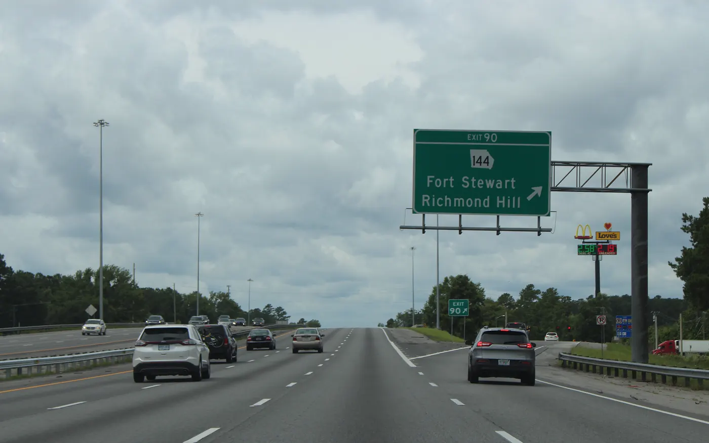 Overhead sign on southbound I-95 at Exit 90 pointing to GA-144, Fort Stewart and Richmond Hill