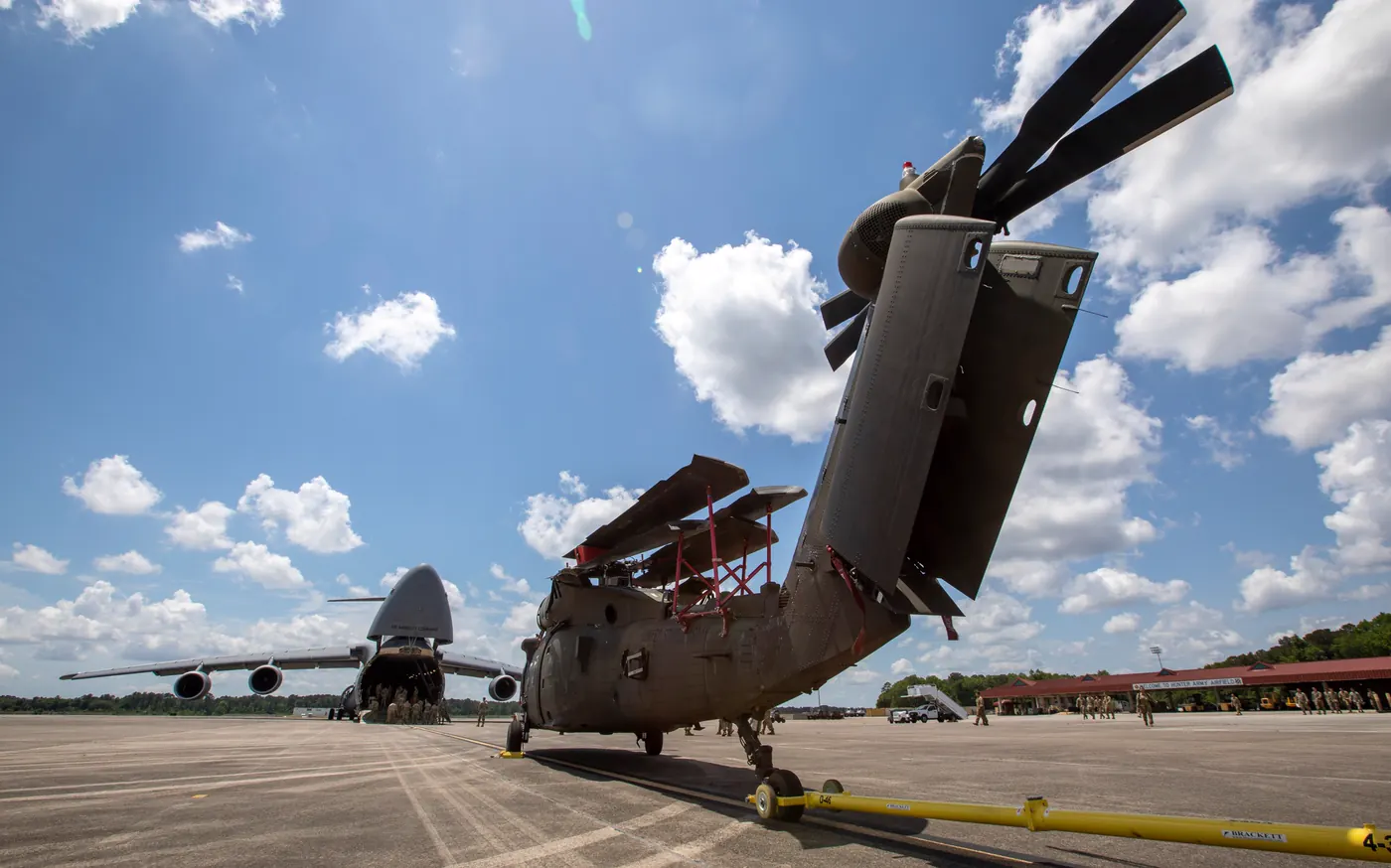 3rd Combat Aviation Brigade soldiers loading a UH-60 Black Hawk onto a C-5M cargo plane on the Hunter Army Airfield ramp in Savannah